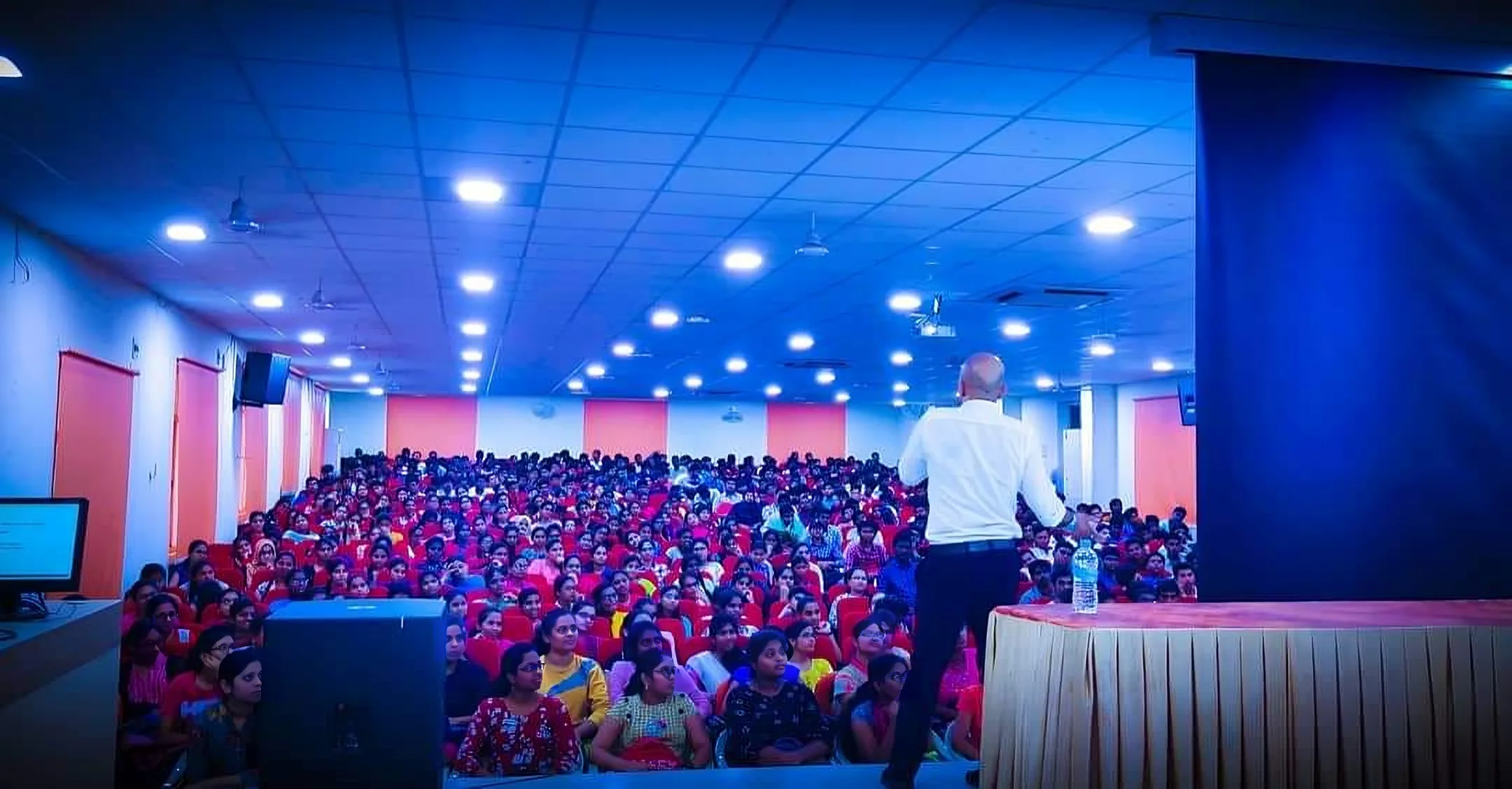 An Abigya trainer speaking to a student audience